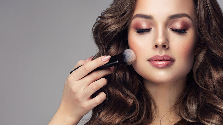 Model applying luxury makeup products for a flawless and radiant look with soft lighting
