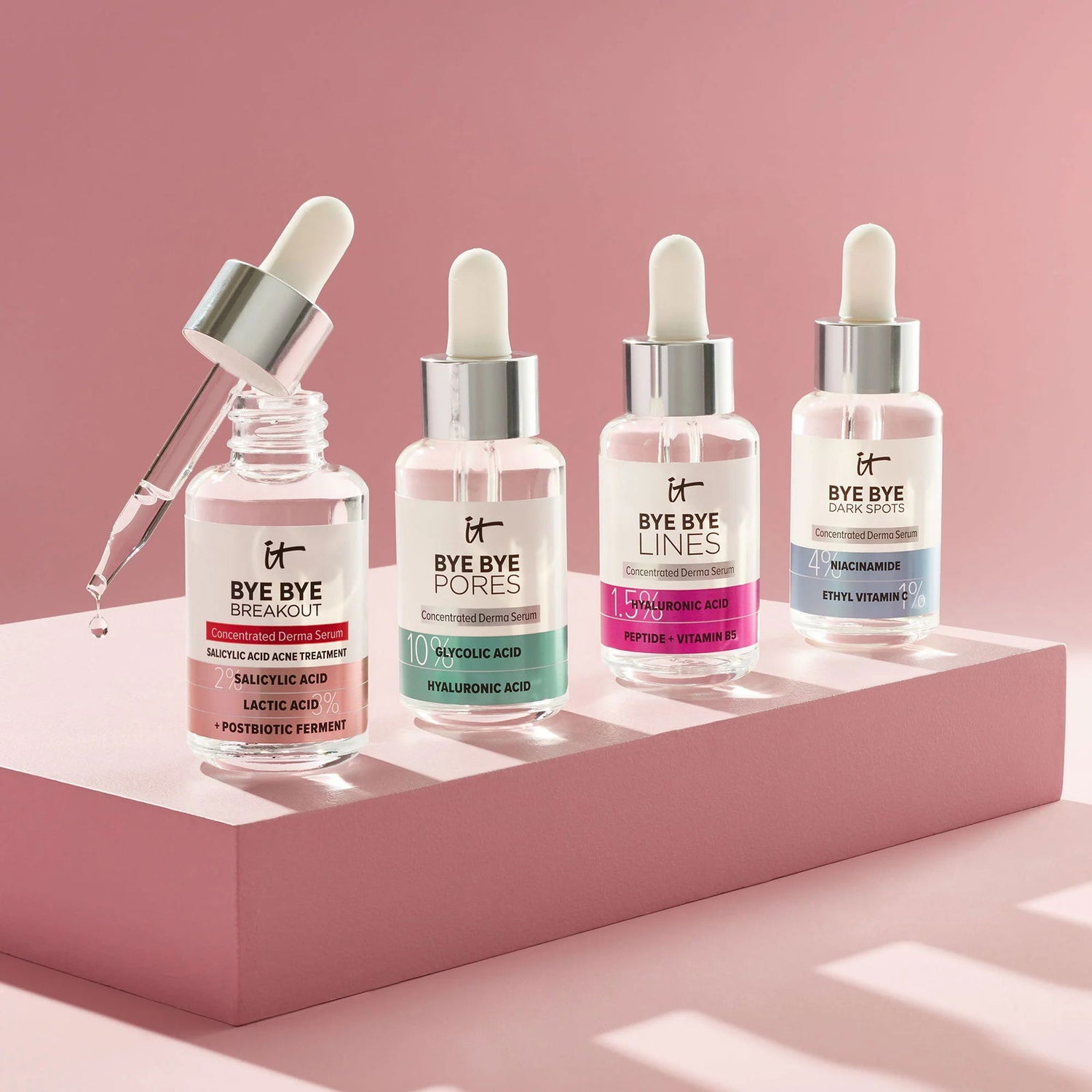 Hydrating serums for dry skin displayed in bottles with droppers on a pink background at Pinky Cosmetics